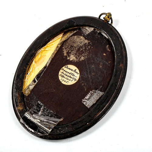 1166 - A pressed tortoiseshell plaque, depicting Queen Anne, by O Brisset, 1705, oval ebony frame overall 1... 