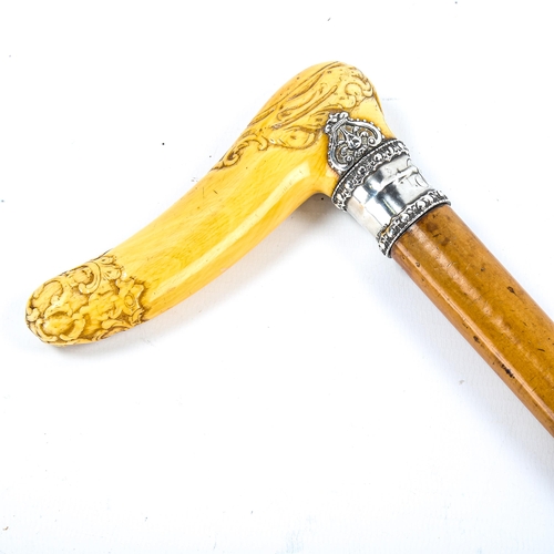 1170 - A 19th century French carved ivory-handled walking cane, with unmarked silver collar with coronet mo... 