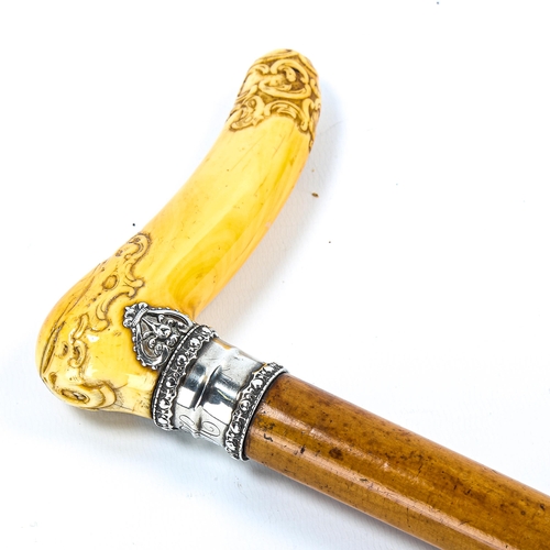 1170 - A 19th century French carved ivory-handled walking cane, with unmarked silver collar with coronet mo... 