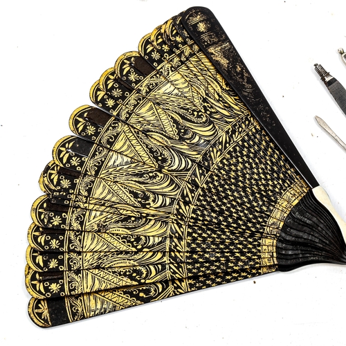 1188 - A 19th century gilded and lacquered fan, length 15cm, and a 19th century surgeon's set in original T... 