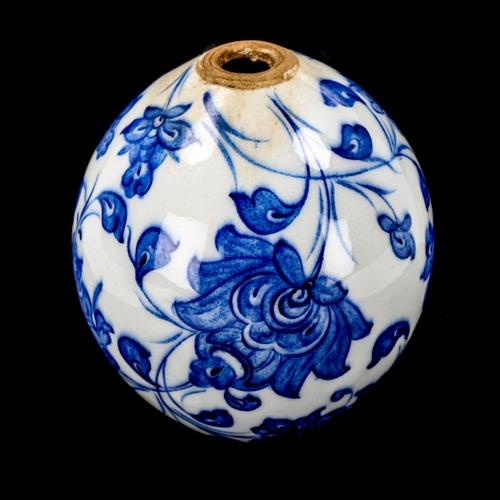 1213 - A Turkish blue and white pottery hanging ball ornament, height 13cm