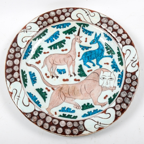 1217 - A Turkish Iznik pottery plate with painted animal designs, diameter 31cm