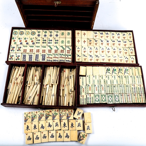 1227 - A Chinese bone and bamboo Mahjong set, in original brass-bound hardwood cabinet, with brass carrying... 