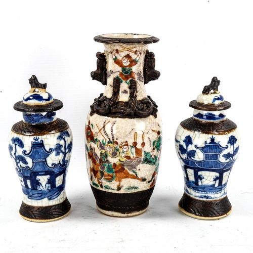 1232 - A Chinese porcelain vase with applied dragon decoration, height 21cm, and a pair of blue and white c... 