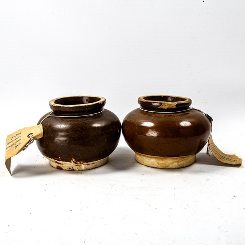 1233 - A pair of Thai brown glaze pottery jars, diameter 11cm, with attached export documents