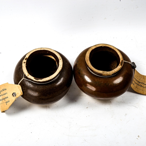 1233 - A pair of Thai brown glaze pottery jars, diameter 11cm, with attached export documents