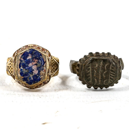 1242 - A Medieval bronze seal ring, and an unmarked yellow metal seal ring with lapis panel (2)