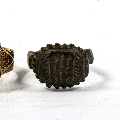 1242 - A Medieval bronze seal ring, and an unmarked yellow metal seal ring with lapis panel (2)