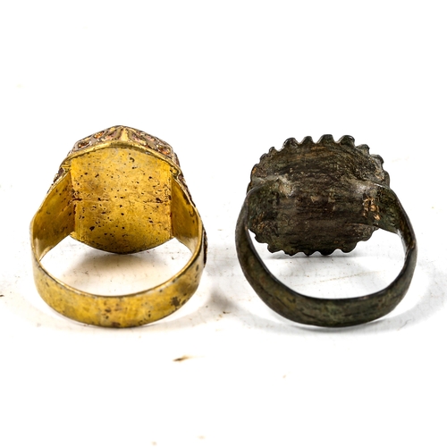 1242 - A Medieval bronze seal ring, and an unmarked yellow metal seal ring with lapis panel (2)