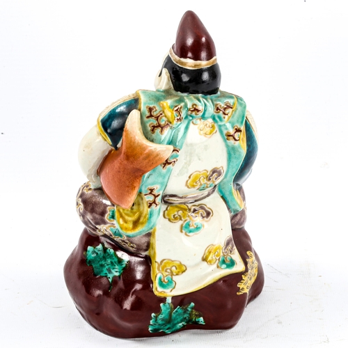 1245 - A Chinese porcelain figure of a man holding a carp, early 20th century, height 20cm