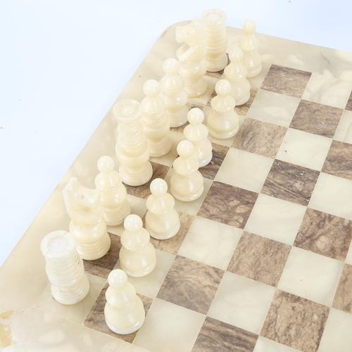 1273 - An onyx chess set on onyx games board