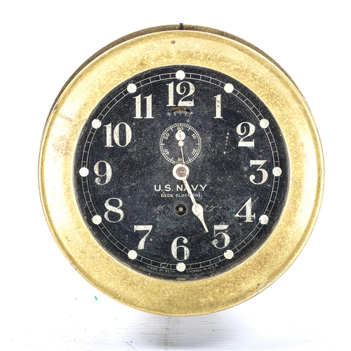 68 - A brass US Navy Deck bulkhead Clock No. 1, by Seth Thomas, black dial with Arabic numerals and subsi... 