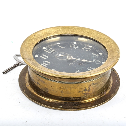 68 - A brass US Navy Deck bulkhead Clock No. 1, by Seth Thomas, black dial with Arabic numerals and subsi... 