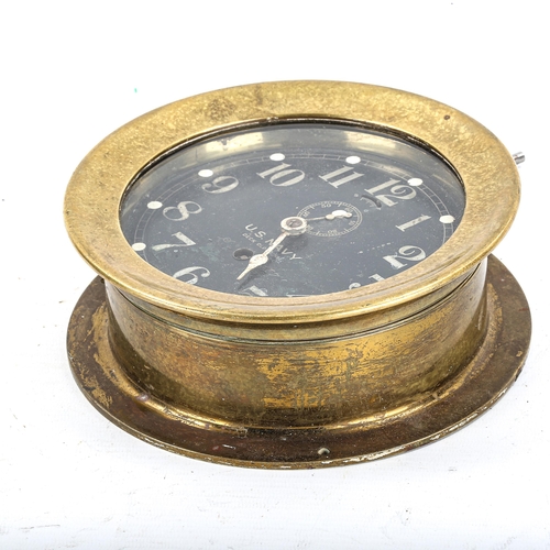 68 - A brass US Navy Deck bulkhead Clock No. 1, by Seth Thomas, black dial with Arabic numerals and subsi... 