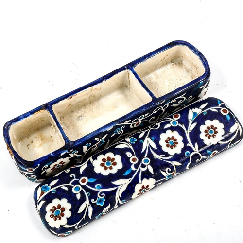 1208 - A Turkish Iznik pottery pen box with painted decoration, length 27cm