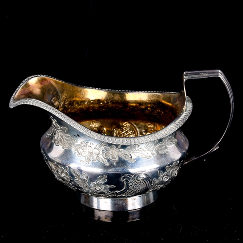 117 - A George III silver cream jug, circular squat form with relief embossed floral decoration, gadrooned... 