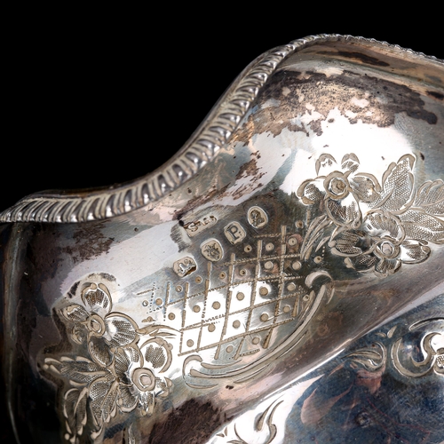 117 - A George III silver cream jug, circular squat form with relief embossed floral decoration, gadrooned... 