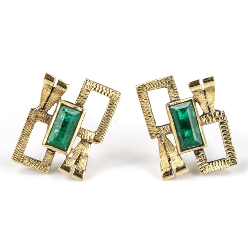 132 - A pair of late 20th century emerald abstract stud earrings, unmarked gold geometric openwork and tex... 