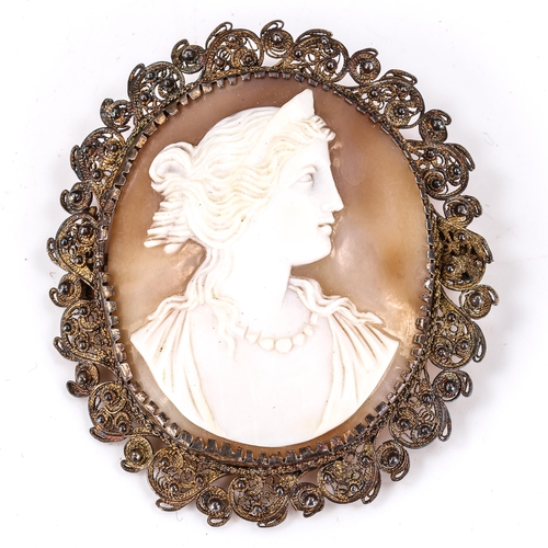 183 - A Victorian shell cameo brooch, depicting Greek lady profile, in unmarked silver filigree frame, bro... 