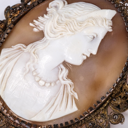 183 - A Victorian shell cameo brooch, depicting Greek lady profile, in unmarked silver filigree frame, bro... 