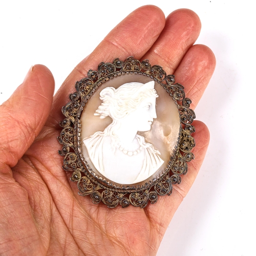 183 - A Victorian shell cameo brooch, depicting Greek lady profile, in unmarked silver filigree frame, bro... 