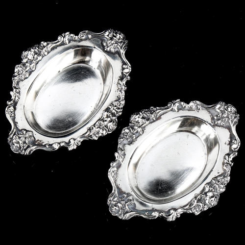 186 - MAPPIN & WEBB - a pair of George V cast-silver pin dishes, with cast floral and foliate rims, hallma... 