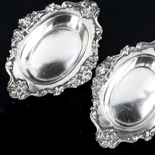 186 - MAPPIN & WEBB - a pair of George V cast-silver pin dishes, with cast floral and foliate rims, hallma... 