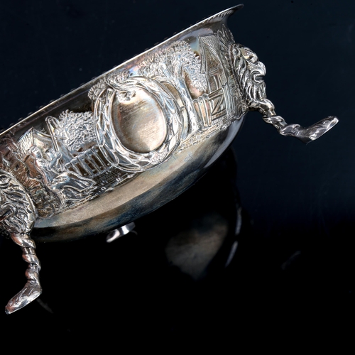 187 - An Edwardian Irish silver bowl, relief embossed farmyard scenes with lion mask and paw feet, by Samu... 