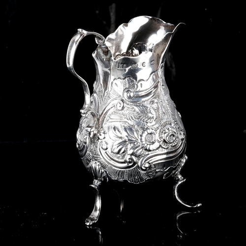 209 - A Victorian silver cream jug, baluster form with relief embossed foliate decoration, by Mitchell Bos... 