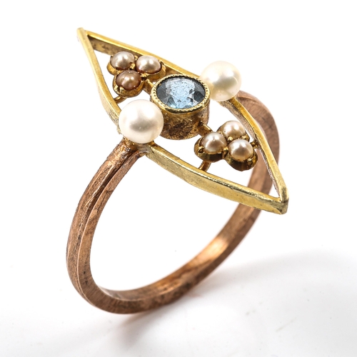 216 - An Edwardian Art Nouveau blue topaz and pearl panel ring, openwork unmarked gold settings, setting h... 