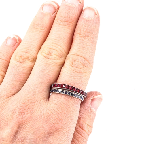 220 - 2 gem set eternity rings, comprising calibre-cut ruby and round-cut sapphire, unmarked white metal s... 