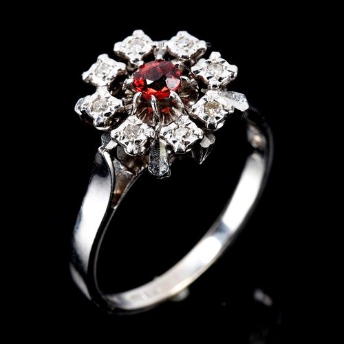 221 - A late 20th century 18ct white gold ruby and diamond cluster snowflake ring, set with round-cut ruby... 