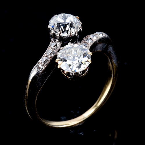 226 - An Antique diamond crossover ring, unmarked gold settings with old European-cut principal diamonds a... 