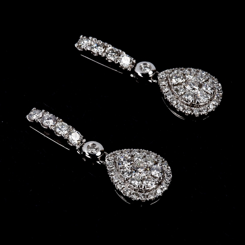 228 - A pair of modern 18ct white gold diamond cluster pear-drop stud earrings, set with modern round bril... 