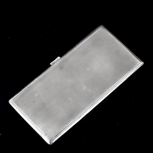 234 - A large George VI Art Deco silver cigarette case, rectangular form with allover engine turned decora... 