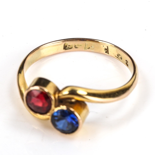 275 - An unmarked gold gem set crossover ring, set with red and blue stones, setting height 8.5mm, size N,... 