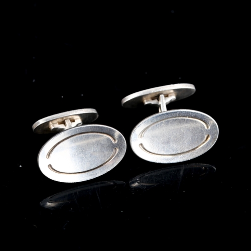 295 - GEORG JENSEN - a pair of Danish stylised sterling silver oval panel cufflinks, designed by Poul Hans... 