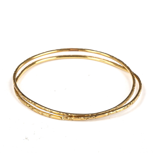 368 - A pair of Indian unmarked gold bangles, tests as 18ct, diameter 6cm, 11.9g total (2)