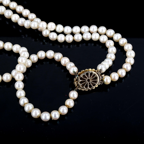 370 - A Vintage double-strand pearl necklace, with textured 9ct clasp, necklace length 56cm, 77.5g