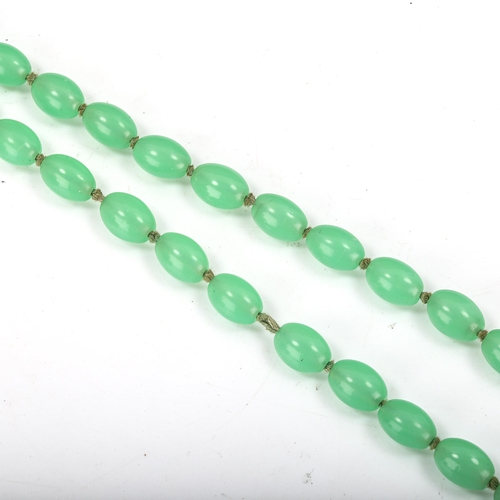 372 - A 1930s uranium glass bead necklace, individually knotted, bead length 13.3mm, necklace length 76cm,... 