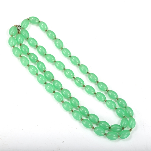 372 - A 1930s uranium glass bead necklace, individually knotted, bead length 13.3mm, necklace length 76cm,... 