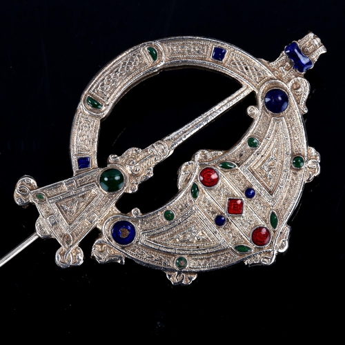 375 - An Irish Celtic Penannular enamel brooch, unmarked white metal settings, brooch length 55.3mm, 13.4g