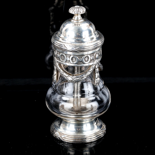 381 - A George V silver-mounted glass pepper mill, baluster form with laurel wreath swags and reeded foot,... 