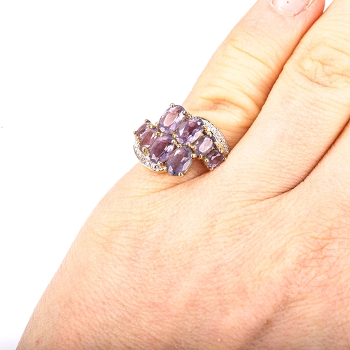 388 - A modern 9ct gold amethyst and diamond crossover ring, set with oval mixed-cut amethyst and single-c... 