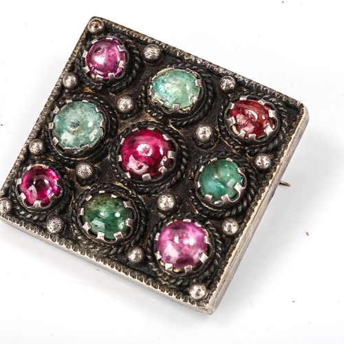 413 - An Arts and Crafts unmarked silver gem set square panel brooch, set with cabochon gem stones, brooch... 