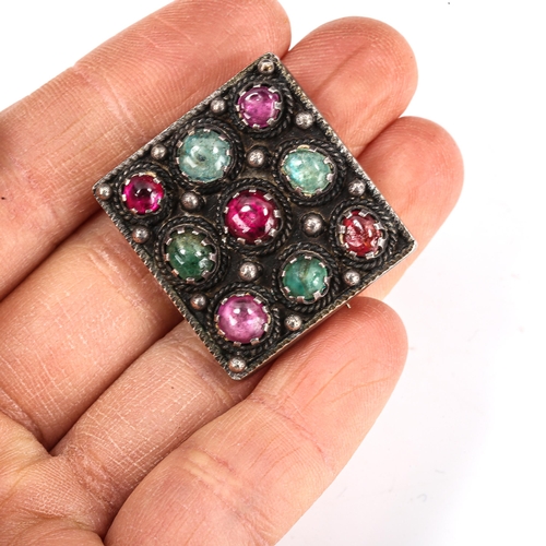 413 - An Arts and Crafts unmarked silver gem set square panel brooch, set with cabochon gem stones, brooch... 