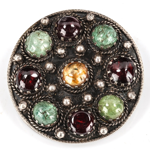 414 - An Arts and Crafts sterling silver gem set circular brooch, cannetille decoration with round cabocho... 