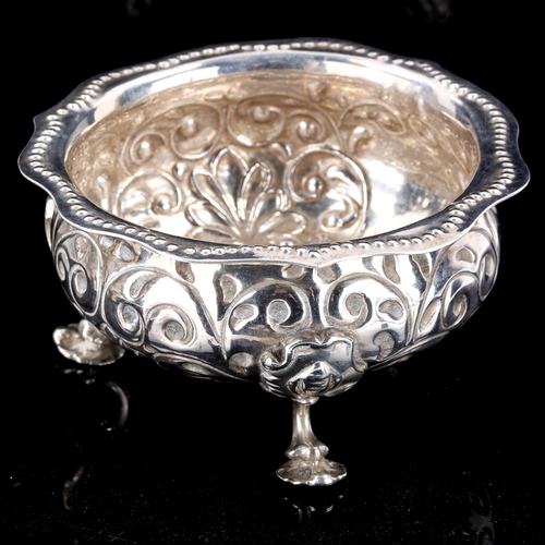 417 - A George III silver bowl, relief embossed foliate decoration with beaded scalloped rim, by George Sm... 