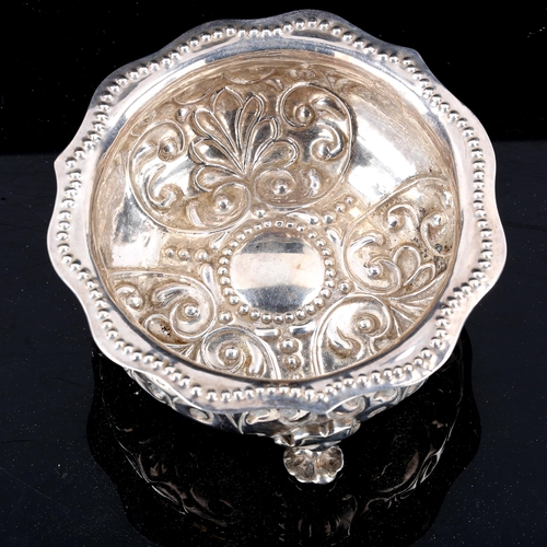 417 - A George III silver bowl, relief embossed foliate decoration with beaded scalloped rim, by George Sm... 