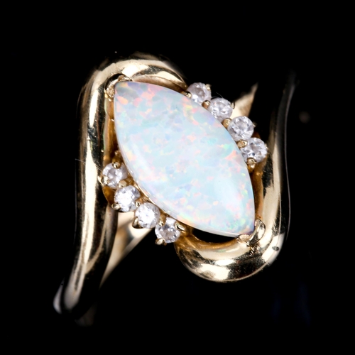 449 - A modern 14ct gold synthetic opal and cubic zirconia crossover ring, set with marquise cabochon synt... 